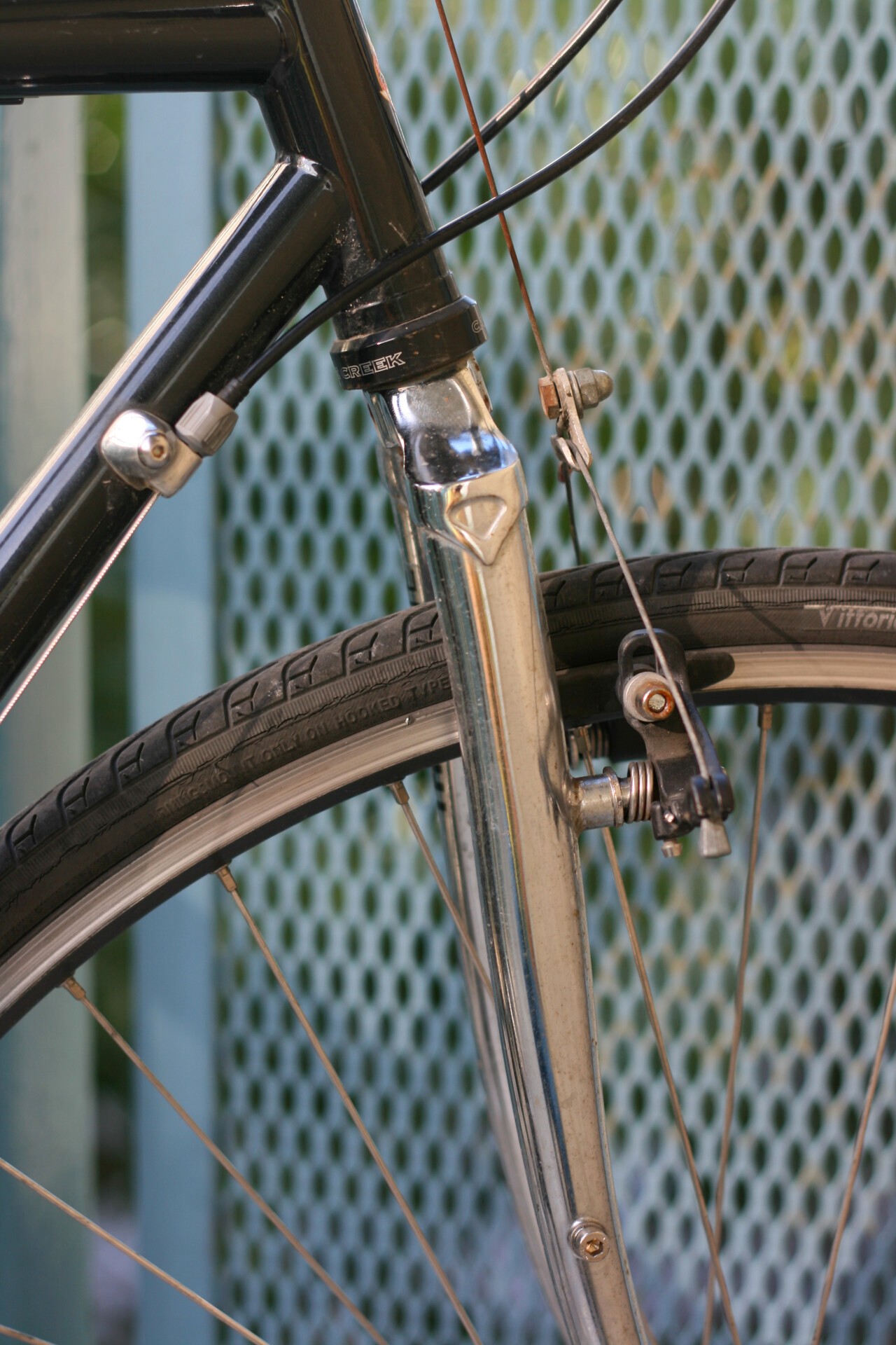 A close-up of a cracked carbon bicycle fork