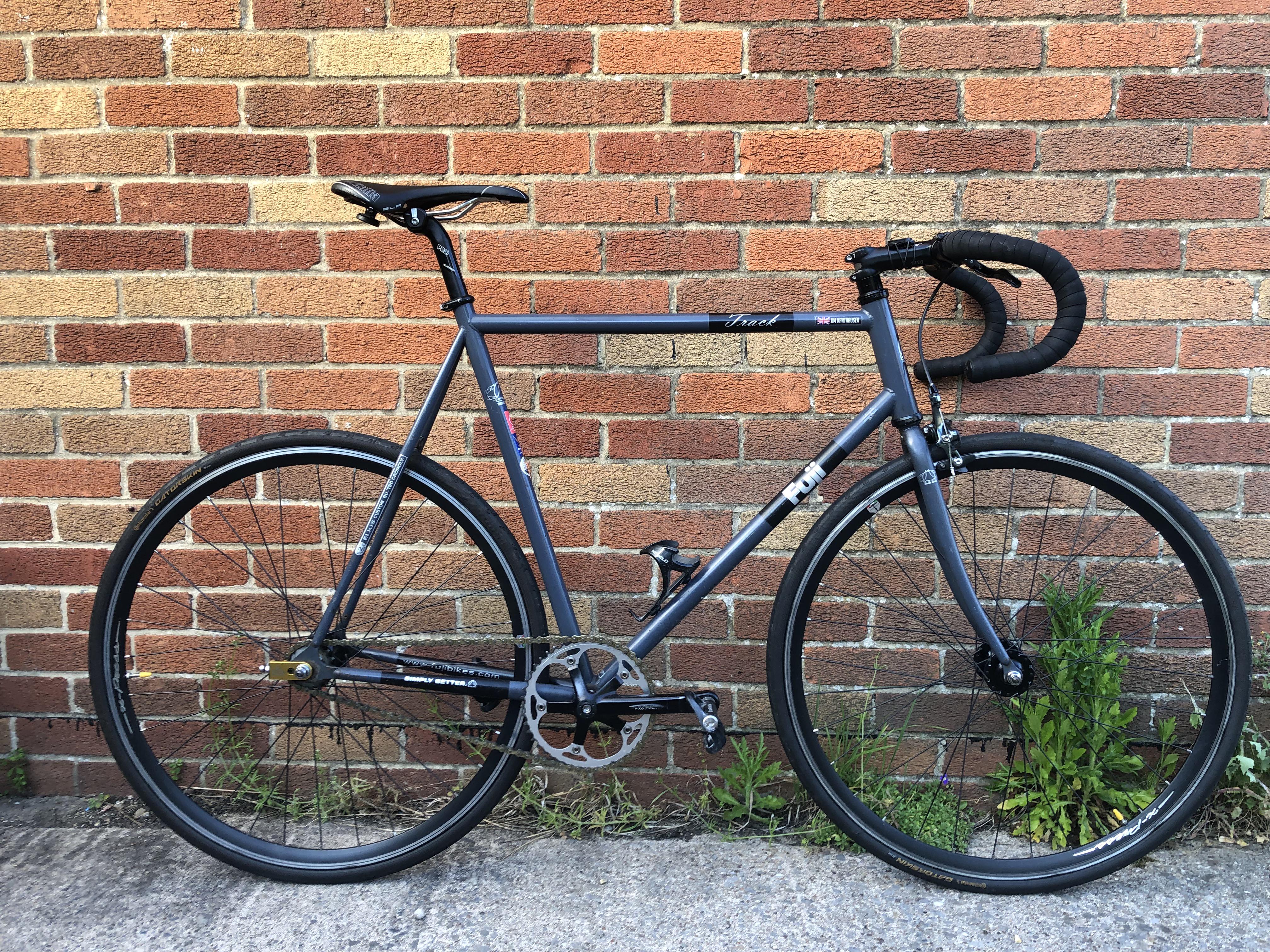 A black fixed-gear track bicycle