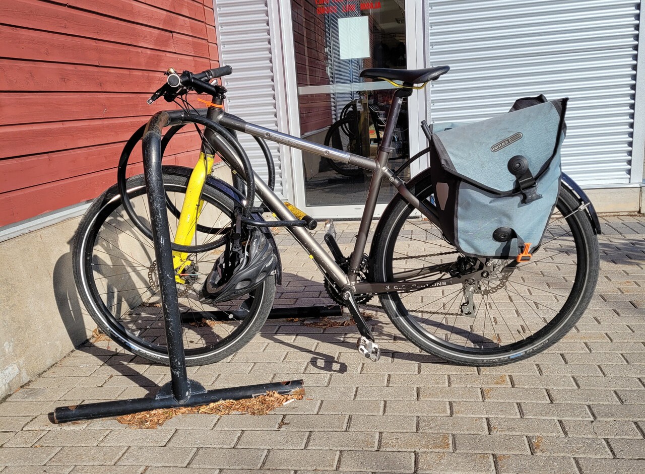 A grey hybrid bicycle with wide tires