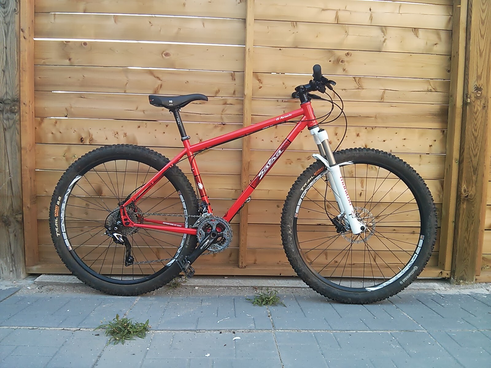 A green mountain bike on a rocky trail