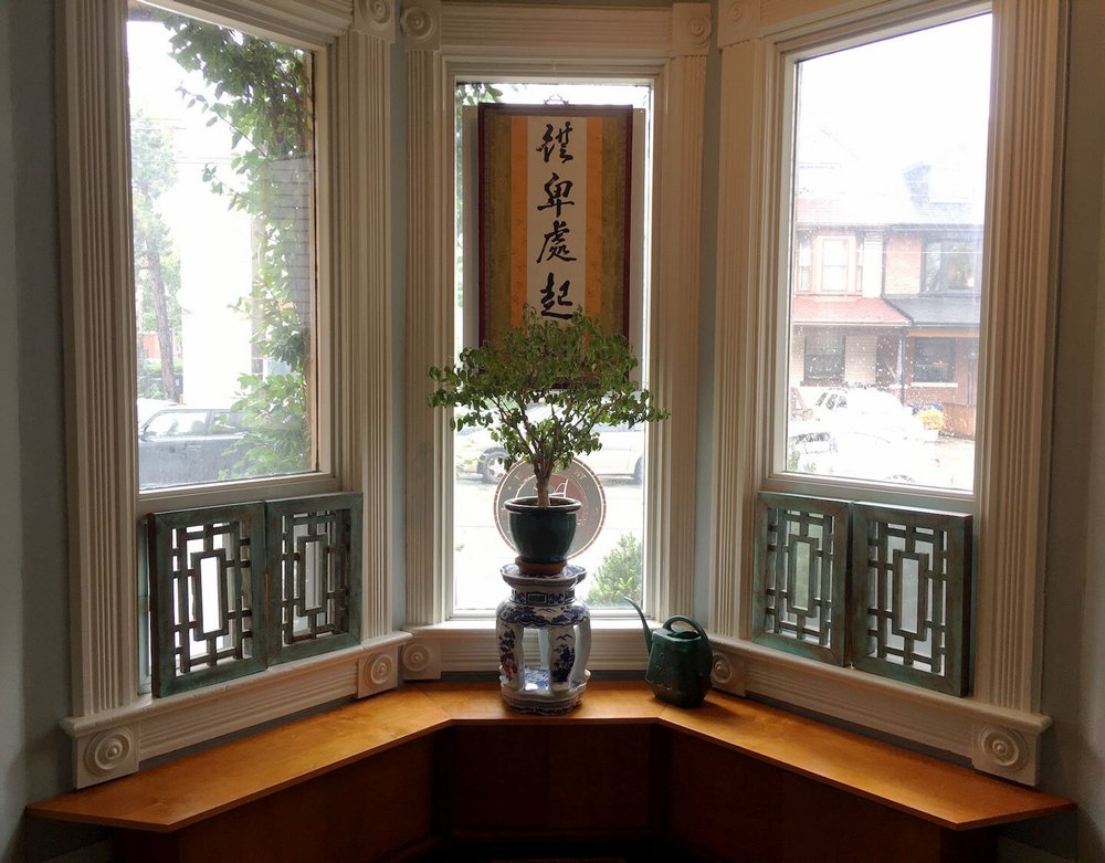 A person performing tai chi movements in a park